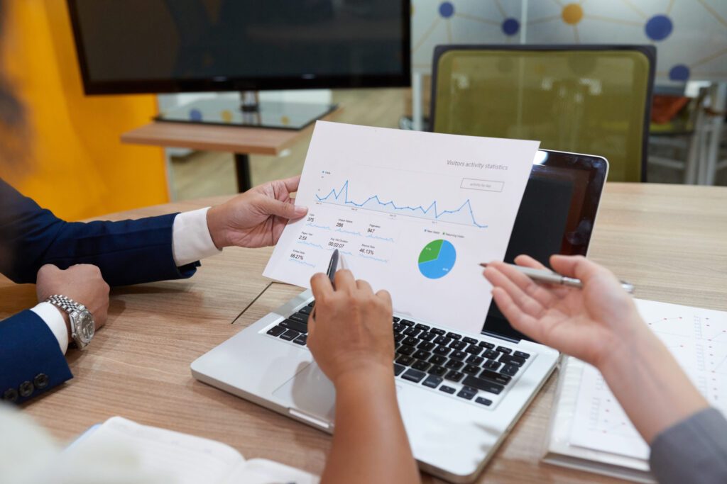 Meeting of financial managers Team reviewing financial charts on a laptop in a meeting