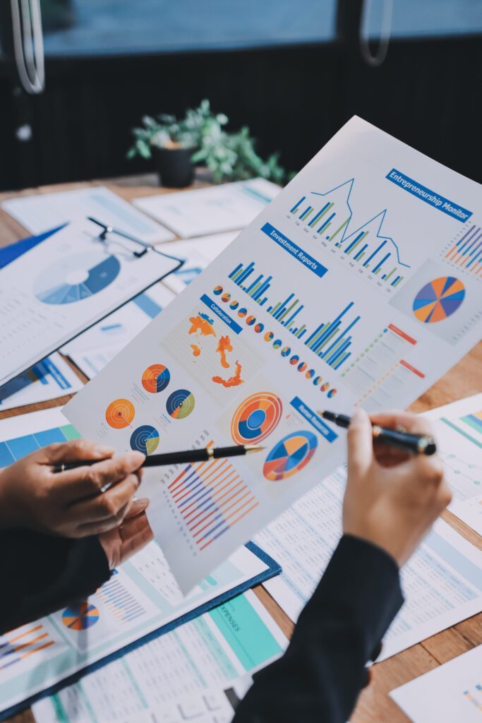 Marketer reviewing printed analytics charts and reports
